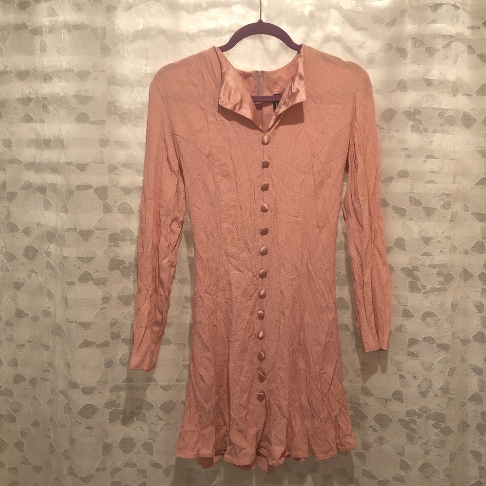 Pink long sleeve dress featuring button detail